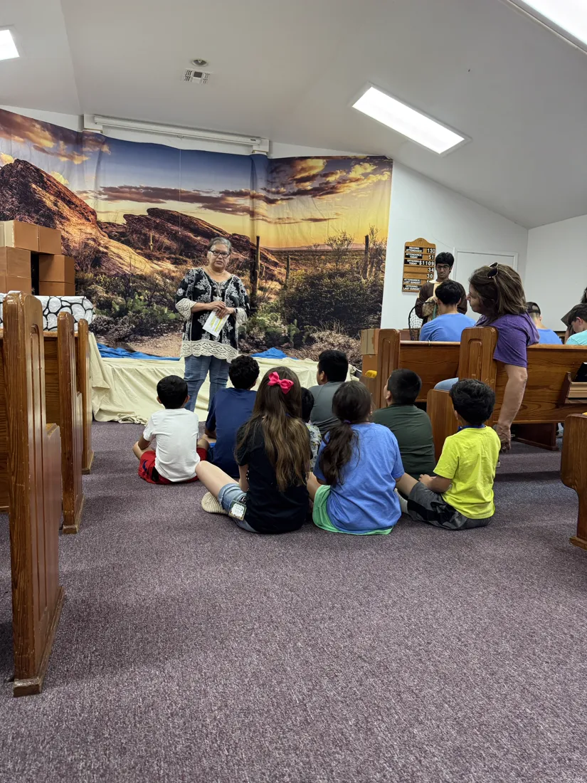 A teacher sharing a Bible lesson with children at Vacation Bible School