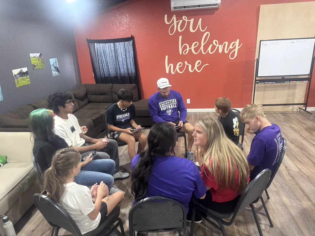 Youth group of Stockdale Church of Christ gathered under a 'you belong here' sign